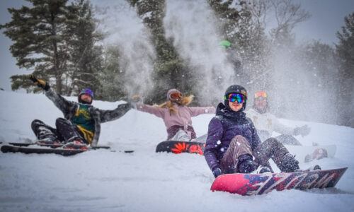 A group of people skiing and snowboarding on the Calabogie Peaks ski hill with season passes