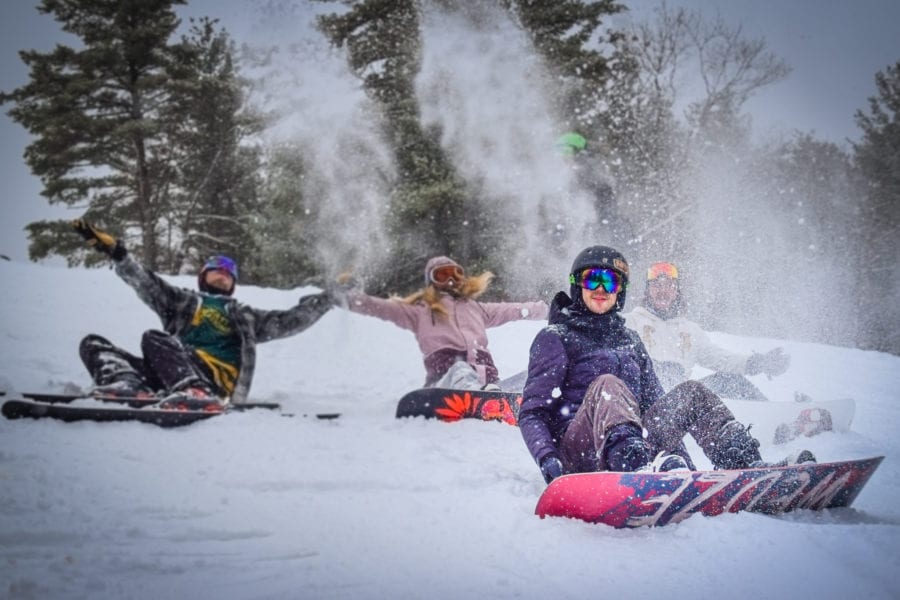 A group of people skiing and snowboarding on the Calabogie Peaks ski hill with season passes